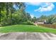 Spacious backyard with a lush lawn, bordered by mature trees, perfect for outdoor activities at 2031 Greyfield Nw Dr, Kennesaw, GA 30152