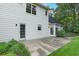Well-maintained backyard features lush green lawn, concrete patio, and mature landscaping at 2031 Greyfield Nw Dr, Kennesaw, GA 30152