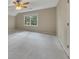 Bright bedroom features neutral walls, plush carpet, a ceiling fan, and a window offering natural light at 2031 Greyfield Nw Dr, Kennesaw, GA 30152
