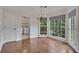 Sunny dining area with bay windows, wood floors, and chandelier at 2031 Greyfield Nw Dr, Kennesaw, GA 30152