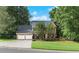 Traditional brick home with a two-car garage, surrounded by mature trees and a lush lawn, offering curb appeal at 2031 Greyfield Nw Dr, Kennesaw, GA 30152