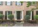 Inviting front entrance with a dark door, brick facade, and manicured landscaping, creating a warm welcome at 2031 Greyfield Nw Dr, Kennesaw, GA 30152