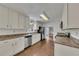 Traditional kitchen features white cabinets, stainless steel appliances, and hardwood flooring at 2031 Greyfield Nw Dr, Kennesaw, GA 30152
