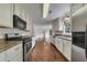 Spacious kitchen featuring stainless steel appliances, white cabinets and wood floors at 2031 Greyfield Nw Dr, Kennesaw, GA 30152