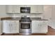White kitchen features stainless steel oven range, countertops, and cabinets at 2031 Greyfield Nw Dr, Kennesaw, GA 30152
