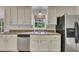 Bright kitchen with stainless steel appliances, white cabinets, and a window over the sink at 2031 Greyfield Nw Dr, Kennesaw, GA 30152