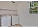 Laundry room with washer, dryer, window and storage shelf at 2031 Greyfield Nw Dr, Kennesaw, GA 30152