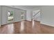 Spacious living room with hardwood floors, large windows, and an open doorway to the foyer, creating a seamless flow at 2031 Greyfield Nw Dr, Kennesaw, GA 30152
