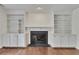 Living room featuring fireplace, built-in shelving, and hardwood floors at 2031 Greyfield Nw Dr, Kennesaw, GA 30152