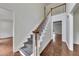 Elegant staircase with carpet runner and wooden handrail, complemented by hardwood flooring and white walls at 2031 Greyfield Nw Dr, Kennesaw, GA 30152