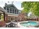 This brick home features a beautiful backyard pool area with a patio and awning, perfect for relaxation and outdoor gatherings at 1006 Arbor Ne Trce, Atlanta, GA 30319