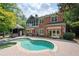 Beautiful backyard featuring a pool, brick patio, cabana, and well-maintained landscaping at 1006 Arbor Ne Trce, Atlanta, GA 30319