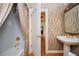 Bathroom showcasing a shower, vanity, and decorated wall as viewed through a doorway at 1006 Arbor Ne Trce, Atlanta, GA 30319