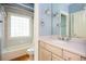 Charming bathroom featuring tiled bath and shower combination and a sink with storage at 1006 Arbor Ne Trce, Atlanta, GA 30319