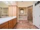 Well-lit bathroom featuring double sinks, a bathtub with tiled surround, and a glass-enclosed shower at 1006 Arbor Ne Trce, Atlanta, GA 30319