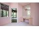 Pink bedroom with a makeup vanity, large mirror, and access to a screened-in porch at 1006 Arbor Ne Trce, Atlanta, GA 30319