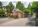 Community entrance gate with manicured landscaping, brick guardhouse, and secure access for residents and guests at 1006 Arbor Ne Trce, Atlanta, GA 30319