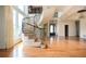 Bright foyer featuring hardwood floors, a grand spiral staircase, and large windows at 1006 Arbor Ne Trce, Atlanta, GA 30319