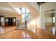 Elegant foyer features a grand spiral staircase, hardwood floors, and a built-in bar area at 1006 Arbor Ne Trce, Atlanta, GA 30319
