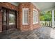 Inviting front entrance featuring a brick facade, slate tile floor, and a solid wood door with decorative glass insert at 1006 Arbor Ne Trce, Atlanta, GA 30319