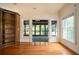 Open living room featuring hardwood floors, built-in shelves, and access to a screened-in porch at 1006 Arbor Ne Trce, Atlanta, GA 30319