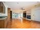 Open living room with hardwood floors, fireplace, and built-in shelving with wet bar at 1006 Arbor Ne Trce, Atlanta, GA 30319