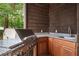 Well-equipped outdoor kitchen area featuring a stainless-steel grill, countertop space and storage, ideal for outdoor entertaining at 1006 Arbor Ne Trce, Atlanta, GA 30319
