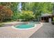 Inviting backyard pool with surrounding brick patio, cabana and lush landscaping, ideal for outdoor relaxation and entertaining at 1006 Arbor Ne Trce, Atlanta, GA 30319