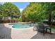 A luxurious pool surrounded by lush landscaping and a brick paver patio, perfect for outdoor relaxation and entertainment at 1006 Arbor Ne Trce, Atlanta, GA 30319