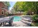 Backyard pool and patio offers a serene retreat, complete with elegant outdoor seating and a lush garden setting at 1006 Arbor Ne Trce, Atlanta, GA 30319