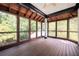 Spacious screened-in porch with wood floors and ceiling, surrounded by trees at 1006 Arbor Ne Trce, Atlanta, GA 30319