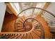 Beautiful spiral staircase with wooden steps and iron railings under an atrium of windows at 1006 Arbor Ne Trce, Atlanta, GA 30319
