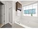 Bright bathroom featuring a soaking tub with jets and a separate glass shower enclosure at 1334 Gates Se Dr, Atlanta, GA 30316