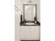 Well-lit powder room with decorative mirror, sleek fixtures, and granite countertop at 1334 Gates Se Dr, Atlanta, GA 30316