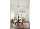 Cozy breakfast nook with glass-topped round table and four chairs in a brightly lit room at 1334 Gates Se Dr, Atlanta, GA 30316