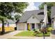 Charming single-Gathering home with a yellow door, a well-manicured lawn, and an attached one-car garage at 1334 Gates Se Dr, Atlanta, GA 30316
