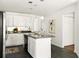 Bright kitchen featuring an island with a sink, black appliances, and white cabinets at 1334 Gates Se Dr, Atlanta, GA 30316