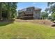 Sprawling backyard featuring a lush lawn and mature trees, with a partial view of the home at 2713 Misty Rock Cv, Dacula, GA 30019