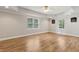 Spacious recreation room featuring durable wood flooring, recessed lighting and bright windows at 2713 Misty Rock Cv, Dacula, GA 30019