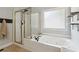 This bathroom provides a jacuzzi tub, a glass enclosed shower and neutral paint at 2713 Misty Rock Cv, Dacula, GA 30019