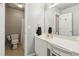 Bright bathroom featuring a vanity with sink, mirror, lighting, and walk in shower and toilet at 2713 Misty Rock Cv, Dacula, GA 30019