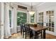 Charming dining area with wooden table, chandelier, and bay window with view of mature trees at 2713 Misty Rock Cv, Dacula, GA 30019