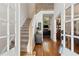 Inviting foyer with hardwood floors, staircase, and view into the living room at 2713 Misty Rock Cv, Dacula, GA 30019