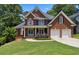 Beautiful brick home featuring an attached two-car garage and landscaped front yard at 2713 Misty Rock Cv, Dacula, GA 30019