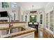Bright kitchen with granite countertops, stainless steel sink and hardwood floors leading to dining area at 2713 Misty Rock Cv, Dacula, GA 30019