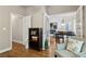 Open-concept living room featuring hardwood floors and natural light, with views into the dining area at 2713 Misty Rock Cv, Dacula, GA 30019