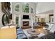 Comfortable living room with fireplace, large windows, and hardwood floors at 2713 Misty Rock Cv, Dacula, GA 30019