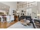 View of living room leading to kitchen with breakfast bar and upstairs loft area at 2713 Misty Rock Cv, Dacula, GA 30019