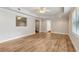 Bright living room featuring wood floors, a tray ceiling with fan and view into an adjacent room at 2713 Misty Rock Cv, Dacula, GA 30019