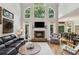 Bright living room with fireplace, hardwood floors and stacked windows leading into a dining area at 2713 Misty Rock Cv, Dacula, GA 30019